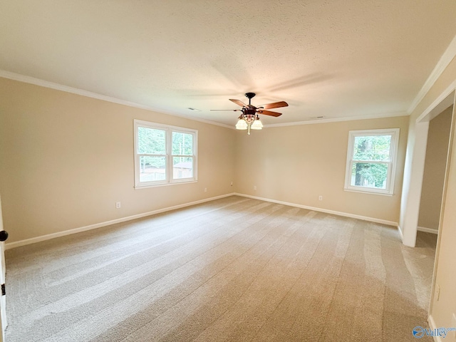 unfurnished room featuring crown molding, plenty of natural light, baseboards, a ceiling fan, and a textured ceiling