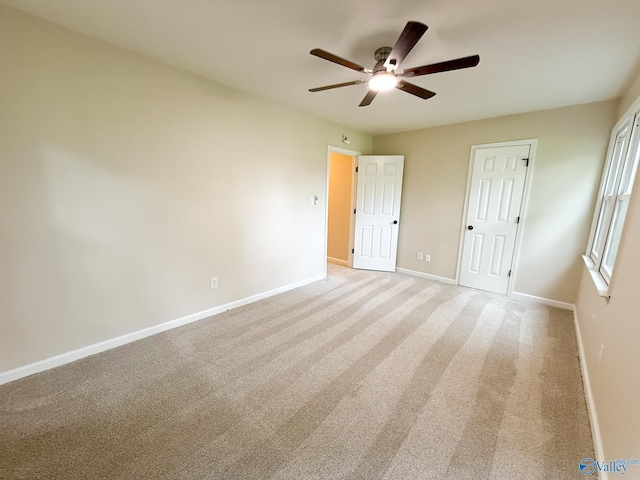 unfurnished bedroom with baseboards, carpet floors, and a ceiling fan