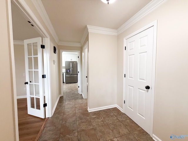 corridor featuring baseboards and ornamental molding