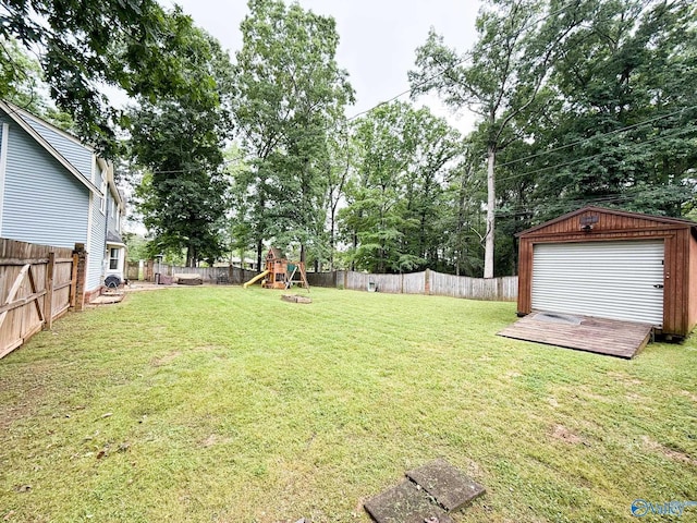 view of yard with a playground and an outbuilding