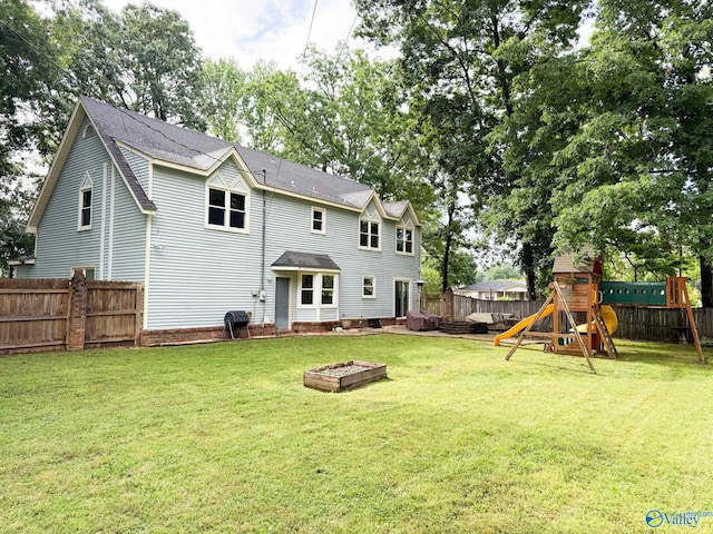 back of house with a playground and roof with shingles
