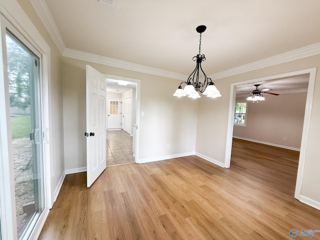 unfurnished dining area with crown molding, light wood-style flooring, baseboards, a chandelier, and ceiling fan