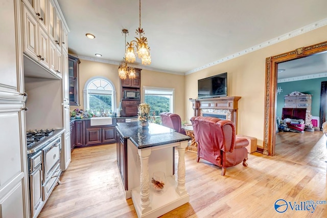 kitchen featuring light hardwood / wood-style floors, a kitchen bar, a center island, and a chandelier