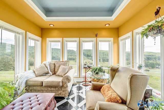 sunroom / solarium with a healthy amount of sunlight and a raised ceiling