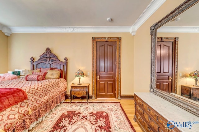 bedroom with light hardwood / wood-style flooring and ornamental molding