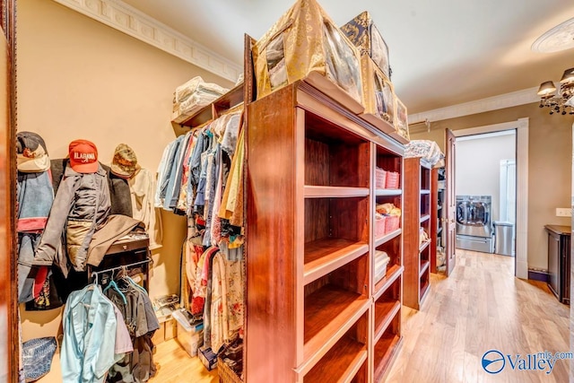 spacious closet with wood-type flooring and separate washer and dryer