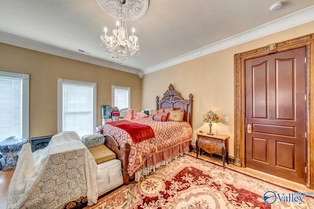 bedroom with ornamental molding, light hardwood / wood-style flooring, and an inviting chandelier