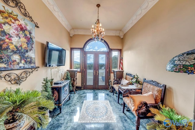 foyer entrance with an inviting chandelier and french doors