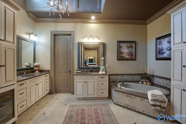 bathroom with vanity, ornamental molding, a notable chandelier, and a relaxing tiled tub