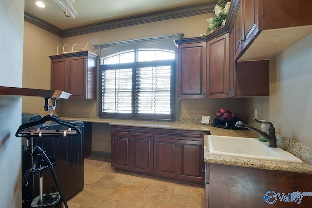 kitchen featuring sink, ornamental molding, and light stone countertops