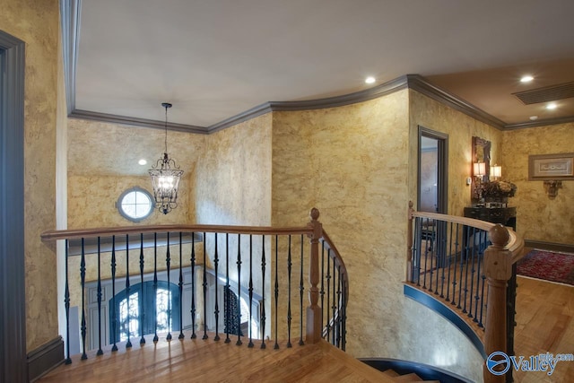 corridor featuring an inviting chandelier, french doors, ornamental molding, and hardwood / wood-style floors