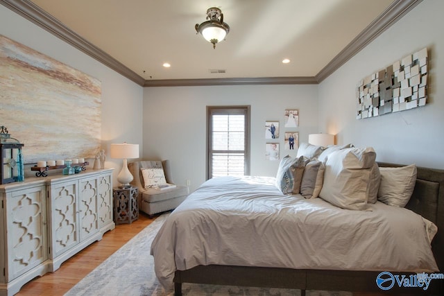 bedroom featuring ornamental molding and light hardwood / wood-style floors