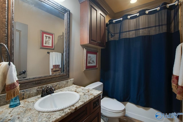 bathroom featuring toilet, vanity, and ornamental molding