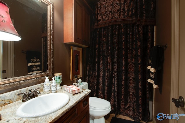 bathroom featuring toilet and vanity