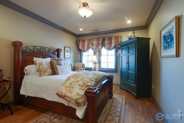 bedroom with crown molding and dark hardwood / wood-style flooring