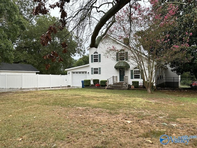 view of front of home with a garage, a front yard, and fence