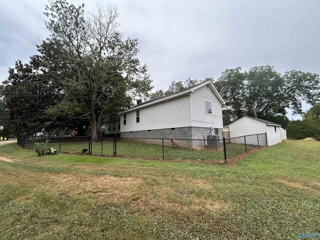 view of property exterior with a yard and fence