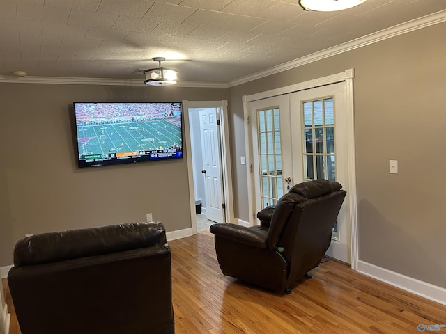 interior space featuring ornamental molding, french doors, baseboards, and light wood finished floors