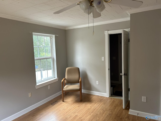 unfurnished room featuring ornamental molding, a ceiling fan, baseboards, and wood finished floors