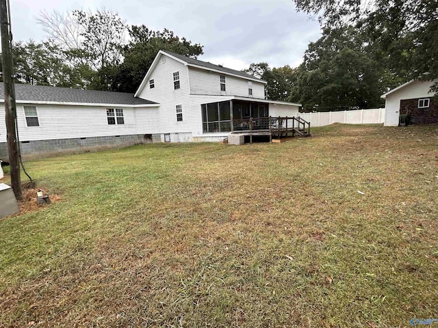 back of house featuring crawl space, a sunroom, fence, and a yard