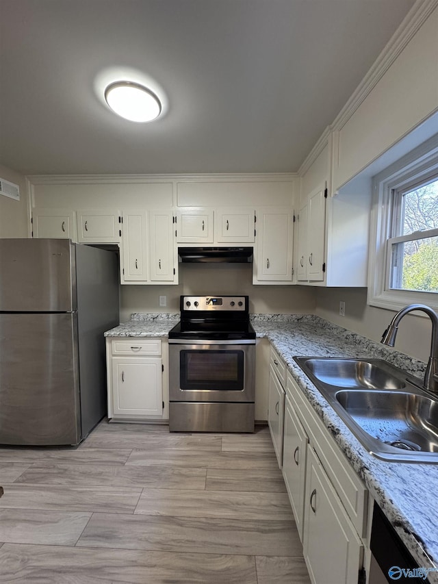 kitchen with sink, appliances with stainless steel finishes, and white cabinets