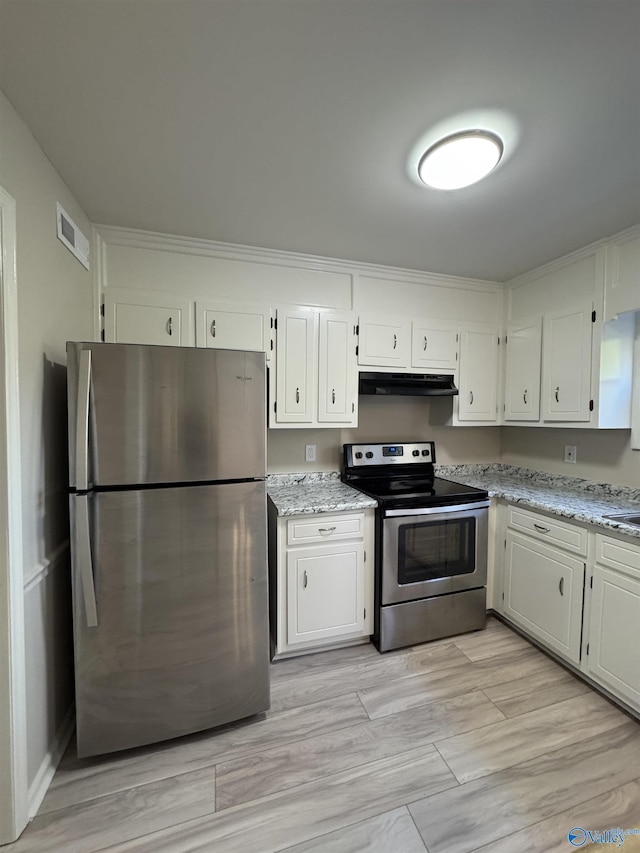 kitchen with appliances with stainless steel finishes, white cabinets, and light stone counters