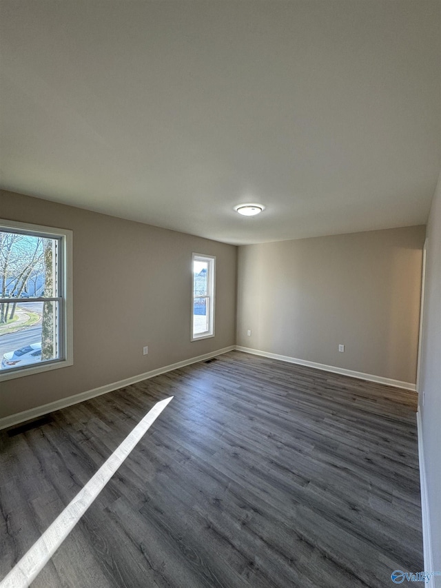 empty room featuring dark wood-type flooring