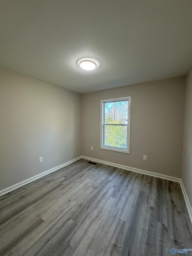 spare room with light hardwood / wood-style flooring