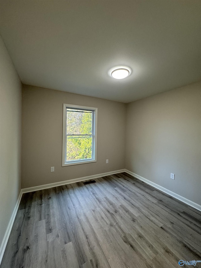 spare room with light hardwood / wood-style flooring