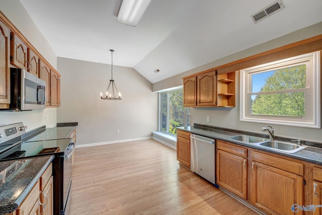 kitchen featuring vaulted ceiling, light wood-style floors, visible vents, stainless steel appliances, and a sink