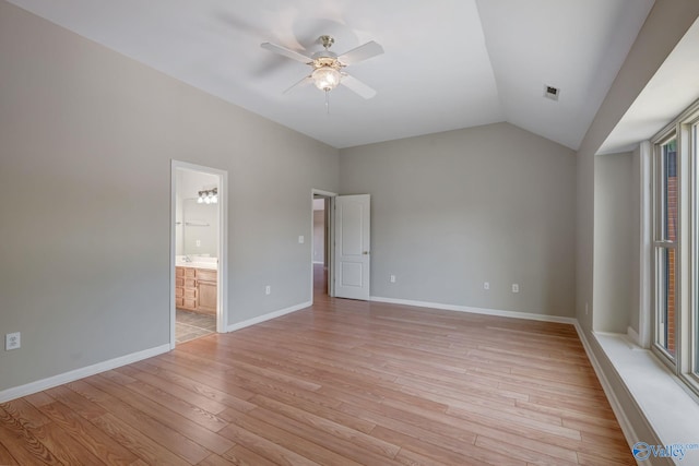 unfurnished bedroom featuring light wood-style floors, baseboards, visible vents, and lofted ceiling