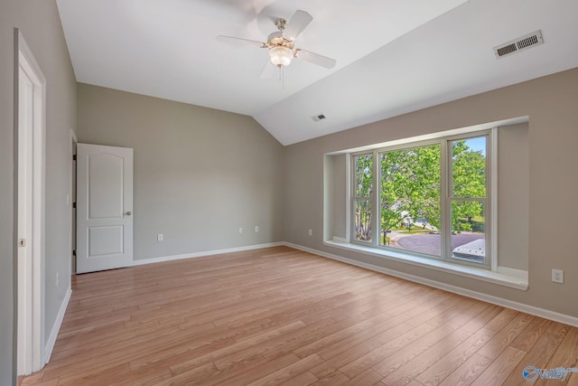 empty room with visible vents, baseboards, ceiling fan, light wood-type flooring, and lofted ceiling