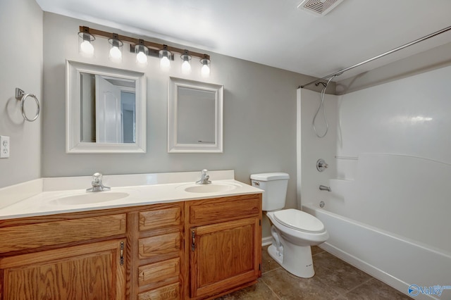 bathroom featuring a sink, visible vents, toilet, and double vanity