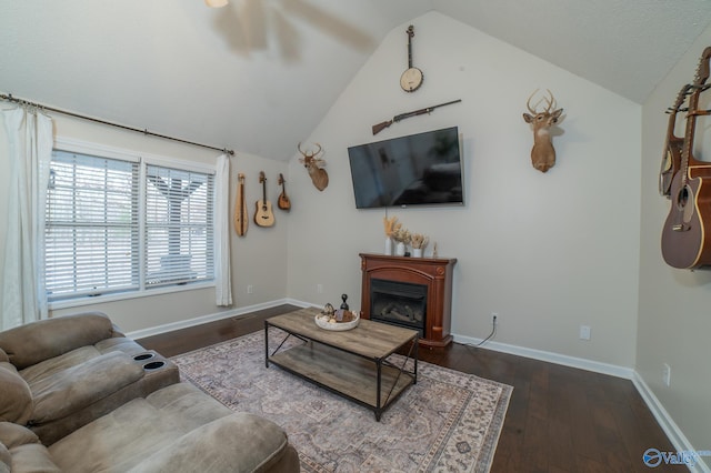 living room with dark hardwood / wood-style floors and vaulted ceiling