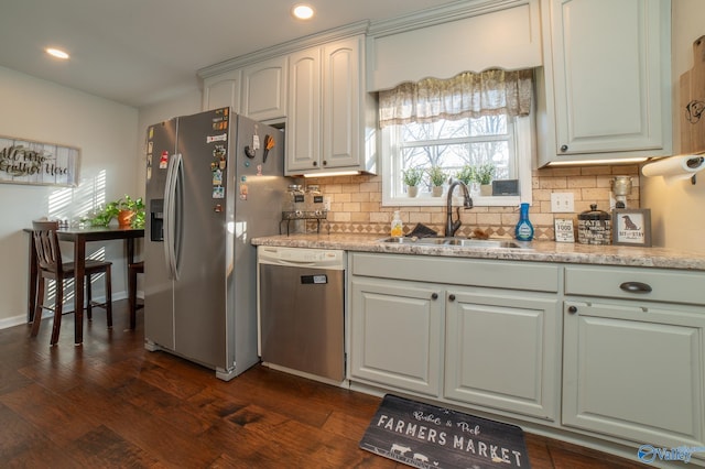 kitchen featuring appliances with stainless steel finishes, dark hardwood / wood-style floors, tasteful backsplash, and sink