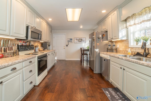 kitchen featuring white cabinetry, sink, dark hardwood / wood-style floors, and appliances with stainless steel finishes