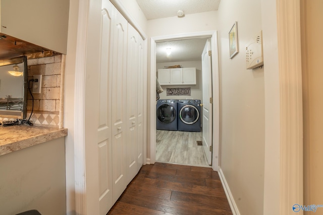 hallway featuring washer and dryer, dark hardwood / wood-style flooring, and a textured ceiling