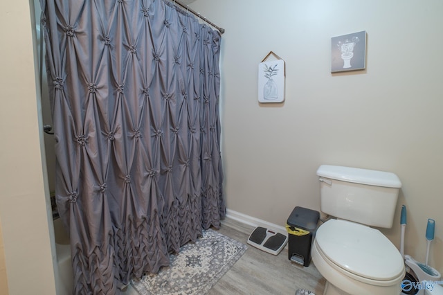 bathroom featuring hardwood / wood-style floors and toilet