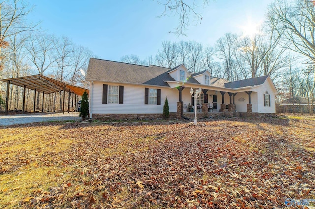 view of front facade featuring covered porch and a carport