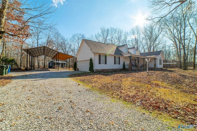 view of front of property with a carport and a garage