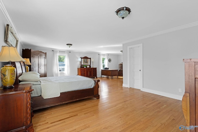 bedroom with light wood finished floors, baseboards, and crown molding
