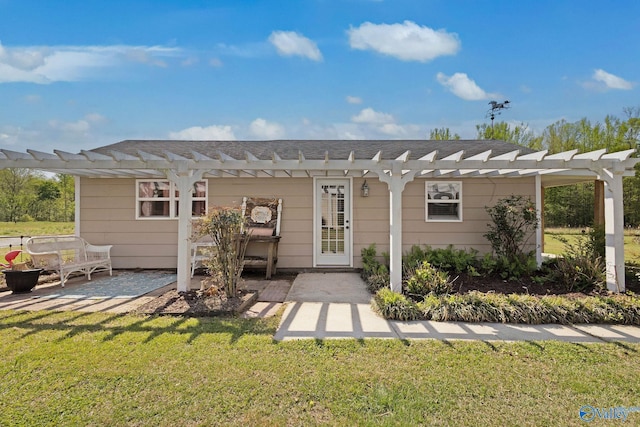 rear view of house featuring a lawn, a pergola, and a patio