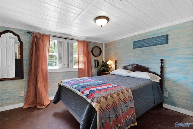 bedroom with wooden ceiling, baseboards, and wooden walls