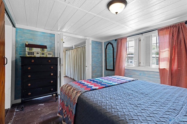 bedroom featuring wood ceiling and finished concrete flooring