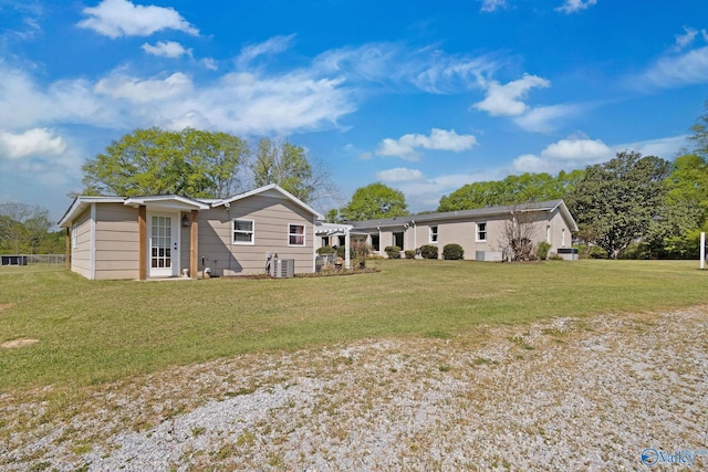 back of house with a lawn and central AC unit