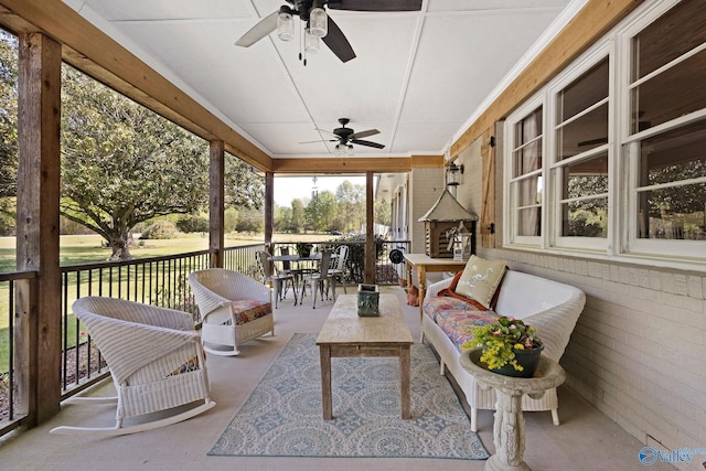 sunroom featuring an outdoor living space, ceiling fan, and outdoor dining area