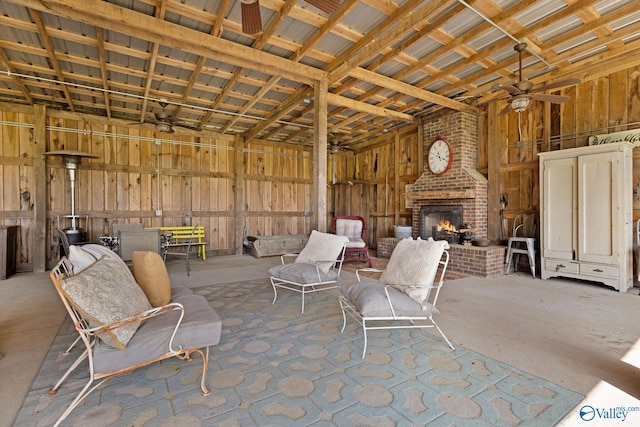 view of patio / terrace featuring fence, an outdoor brick fireplace, and a ceiling fan
