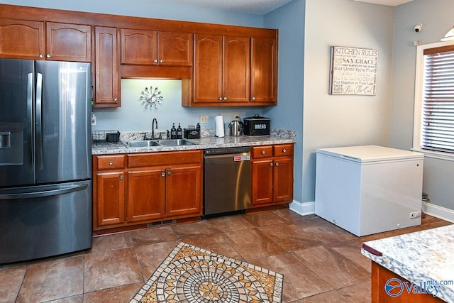 kitchen with light countertops, appliances with stainless steel finishes, a sink, and visible vents