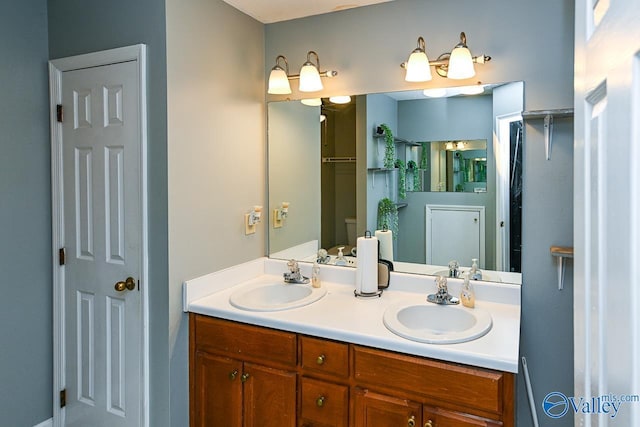 bathroom featuring double vanity, a closet, and a sink