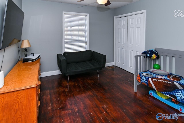 bedroom featuring dark wood-type flooring, a closet, ceiling fan, and baseboards